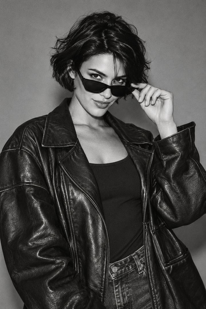 Illustrative black-and-white editorial portrait of a creative wearing sunglasses